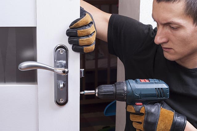 Image featuring a tradie fixing a door